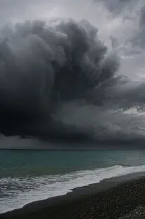 A storm cloud gathering over the sea